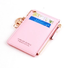 Detailed view of pink PU leather card holder with zipper pocket and gold keychain