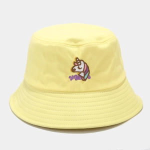 Close-up of a yellow bucket hat featuring cartoon unicorn and Wiggle letter embroidery