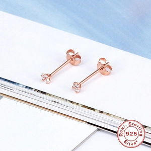 Detail of rose gold 925 sterling silver stud earrings with four-prong zircon setting
