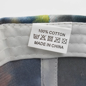 Detail of 100% cotton tag on washed graffiti baseball cap with care instructions