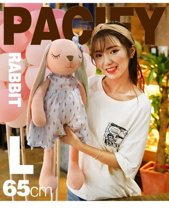 Detailed view of pink plush rabbit doll L size 65cm with blue floral dress being held
