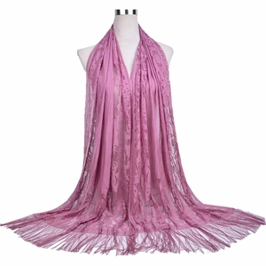 Elegant dusty rose lace shawl with floral embroidery and tassel fringe on mannequin