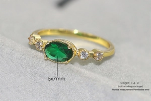 Detail of 5x7mm green oval gemstone ring with 1.6g weight and gold plating detail