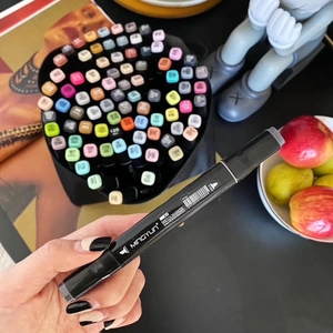 Close-up of a dual-tip art marker with broad and fine nibs for sketching and coloring