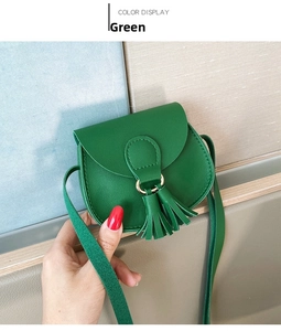 Close-up of a mini green PU leather crossbody bag featuring a decorative fringe tassel detail