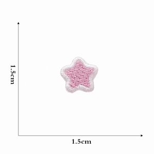 Macro detail of a 1.5cm pink embroidered star patch with white edge stitching