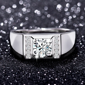 Macro view of a men's silver ring with round brilliant solitaire and side accent stones