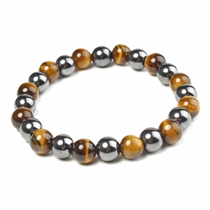 Macro detail of 12mm magnetic hematite and golden tiger eye beads on health bracelet