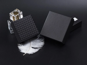 Macro shot of two premium black jewelry gift boxes featuring textured and matte finishes