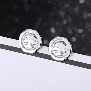 Minimalist silver octagon Tree of Life earrings in stainless steel with bokeh background