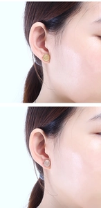 Detailed comparison of gold and silver Tree of Life stud earrings on a model's ear