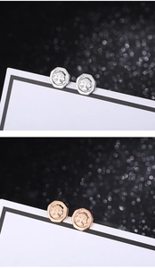 Detail of hexagonal Tree of Life stud earrings in silver and rose gold steel finishes