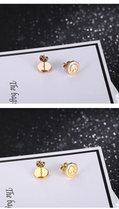 Macro detail of Tree of Life stud earrings with rose gold and gold octagonal base design