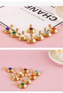 Detailed view of eight vintage style gold plated pendants with colorful round zircons