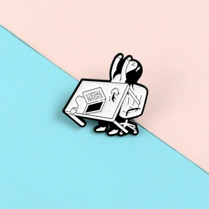 Detailed view of creative enamel brooch featuring an office worker flipping a desk