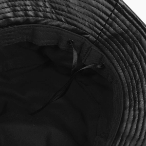 Detail view of black PU leather bucket hat with inner drawstring and breathable lining