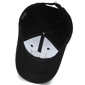 Internal view of black cotton baseball cap showing stitching and 100% cotton label