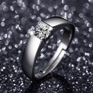 Macro shot of wide silver band ring with brilliant round cut solitaire stone in tension setting