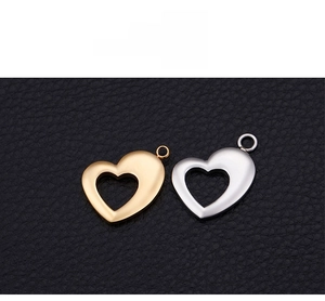 Detail view of heart-shaped hollow charms in gold and silver finish on leather