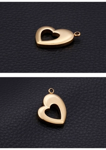 Macro detail of golden heart-shaped stainless steel pendant with hollow center on leather