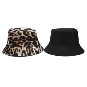 Double-sided cotton bucket hat featuring leopard print and solid black reversible design