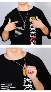 Close-up of vintage Gothic silver cross pendant and necklace shown on a model
