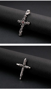 Macro detail of gothic cross pendants with red gemstone on black leather texture