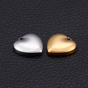Polished stainless steel heart-shaped pendants in gold and silver finish on leather