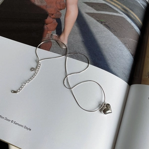 Detail of 925 sterling silver heart pendant necklace with elegant snake chain and clasp