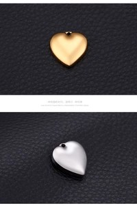 Polished gold and silver heart-shaped stainless steel pendants on black leather