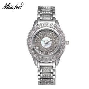 Luxury women's quartz watch with silver steel band and pavé crystals on a white dial