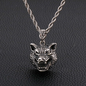 Retro stainless steel dragon head pendant necklace with vintage wolf head on leather background
