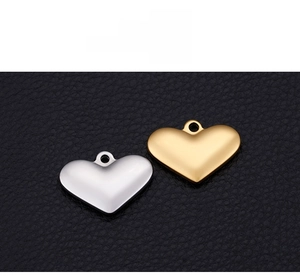 Macro detail of sterling silver heart charms with gold and silver mirror polished finish