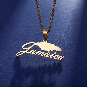 Close-up of golden Jamaica map pendant necklace with scripted text on blue background
