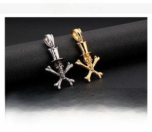 Macro shot of polished punk skull pendants in steel and gold finish on leather