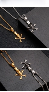 Macro shot of punk skull pendants with top hats in polished gold and silver steel finishes