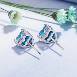 Elegant heart-shaped opal stud earrings with blue stones and silver-tone settings