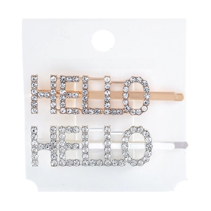 Macro shot of gold and silver HELLO letter hair clips with sparkly rhinestones
