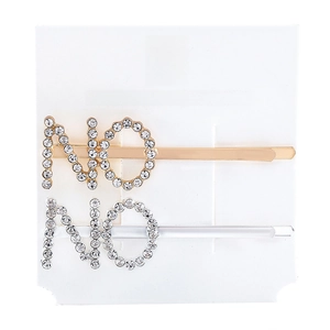 Detailed view of NO letter hair clips in gold and silver finish with crystal rhinestones