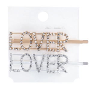 Macro detail of gold and silver LOVER letter hair pins with sparkling rhinestone inlay