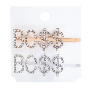 Detail of silver and gold BOSS rhinestone hair clips on a white jewelry card