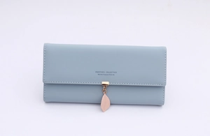Detail of light blue long leather wallet with a pink leaf pendant and engraved slogan