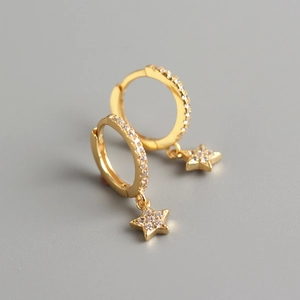 Detail of gold S925 silver star hoop earrings with sparkling cubic zirconia stones