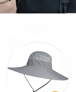 Detail of dark grey sun hat featuring mesh ventilation panels and adjustable windproof cord