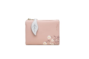 Detailed view of pink floral short wallet featuring a white leaf charm and daisy print