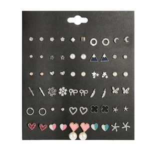 Detailed close-up of 30 pairs of assorted stud earrings with stars and moon designs