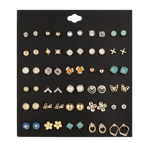 Detail view of 30 pairs of alloy stud earrings with rhinestones on a black card