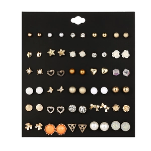 Close-up of 30 pairs alloy stud earrings set with rhinestones and pearls on black card