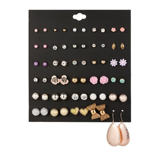Detailed close-up of 30 pairs of floral and crystal stud earrings on black display card