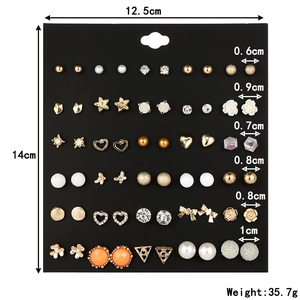 30 pairs of fashion stud earrings set with pearls and rhinestones on a display card